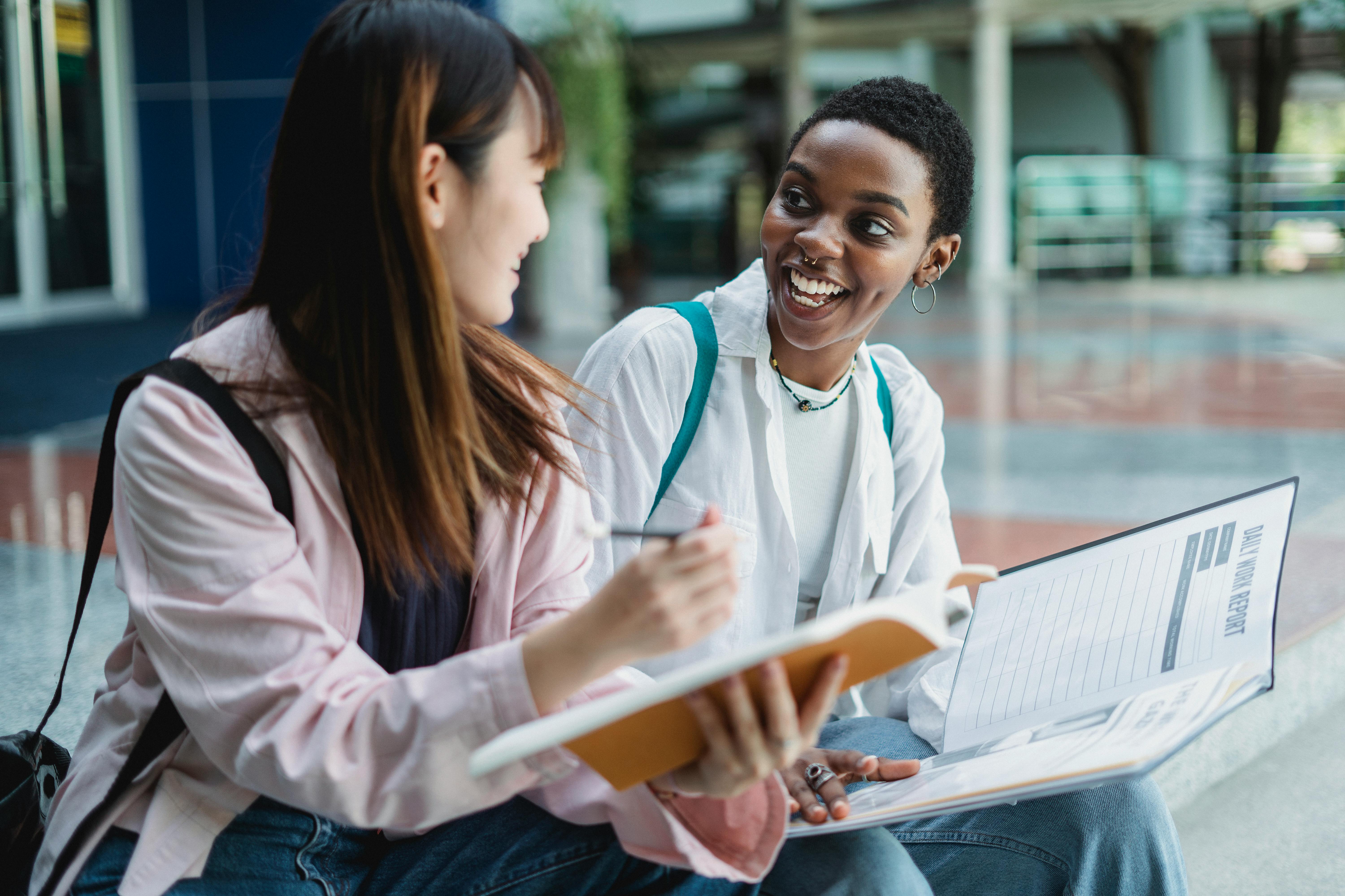 Two students reviewing documents together